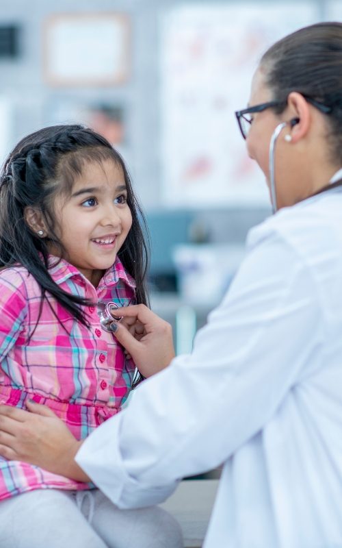 child smiling at the paediatrist