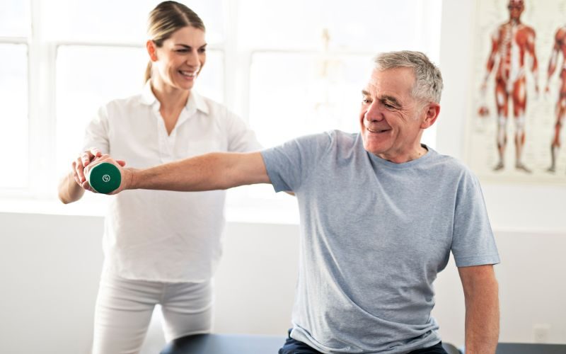 physiotherapist and patient exercising
