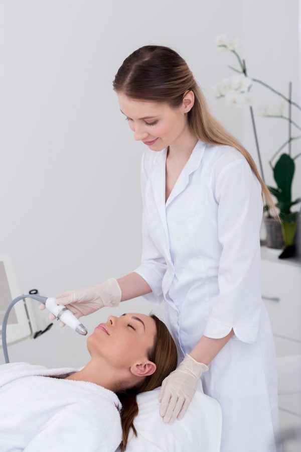 young-woman-getting-facial-treatment-in-cosmetology-salon.jpg